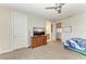 Spacious bedroom with carpeted floor, dresser, and TV at 16625 5Th E Ave, Bradenton, FL 34212