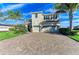 Two-story house with tile roof, three car garage, and palm trees at 16625 5Th E Ave, Bradenton, FL 34212