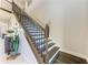 Elegant staircase with dark wood and wrought iron railing at 16625 5Th E Ave, Bradenton, FL 34212