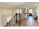 Elegant curved staircase and upper hallway with hardwood floors at 16625 5Th E Ave, Bradenton, FL 34212