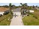 Aerial view of a single-Gathering home with a two-car garage and palm trees at 170 Bonita Dr, Rotonda West, FL 33947