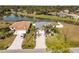 Aerial view of two homes near a lake with mature landscaping at 170 Bonita Dr, Rotonda West, FL 33947