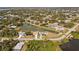 Wide aerial view showcasing the property's location near a lake at 170 Bonita Dr, Rotonda West, FL 33947