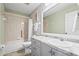 Bathroom with tub, toilet and gray vanity at 170 Bonita Dr, Rotonda West, FL 33947