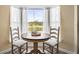 Small dining area with a round table and view of the pool at 170 Bonita Dr, Rotonda West, FL 33947