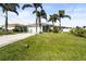 Single-story home with a green lawn and palm trees at 170 Bonita Dr, Rotonda West, FL 33947