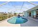 Relaxing kidney-shaped pool with screened enclosure at 170 Bonita Dr, Rotonda West, FL 33947