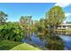 This waterfront backyard has an oversized pond with lush vegetation and a private dock at 1705 Shoreland Dr, Sarasota, FL 34239