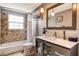 Bathroom featuring gray walls, marble tiled shower, floating vanity with sink, and modern fixtures at 1705 Shoreland Dr, Sarasota, FL 34239