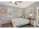 Serene bedroom featuring natural light from shuttered windows and hardwood floors at 1705 Shoreland Dr, Sarasota, FL 34239