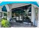 Elegant storefront with blue awnings, decorative columns, and classic benches, inviting customers to enter at 1705 Shoreland Dr, Sarasota, FL 34239