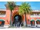 Morton's Market entrance with palm trees, arched entryway, and Mediterranean-style facade in a vibrant setting at 1705 Shoreland Dr, Sarasota, FL 34239