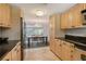 Bright kitchen leading into dining area, stainless steel appliances, granite counters and cabinets at 1705 Shoreland Dr, Sarasota, FL 34239