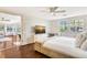 Bright main bedroom with hardwood floors, sunset television view, and a sliding door to living area at 1705 Shoreland Dr, Sarasota, FL 34239