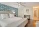 Bright main bedroom with a ceiling fan, a blue accent wall, and hardwood floors at 1705 Shoreland Dr, Sarasota, FL 34239