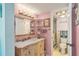 Pink bathroom with updated vanity and a separate shower and toilet at 1770 Benjamin Franklin Dr # 407, Sarasota, FL 34236