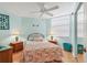 Bedroom with flamingo bedding and ceiling fan at 1770 Benjamin Franklin Dr # 407, Sarasota, FL 34236