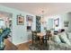 Bright dining area with light wood table and chairs, and a view into the kitchen at 1770 Benjamin Franklin Dr # 407, Sarasota, FL 34236