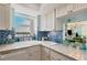 Charming kitchen with blue tile backsplash and ocean view at 1770 Benjamin Franklin Dr # 407, Sarasota, FL 34236