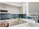 Bright kitchen with ocean views and white cabinets at 1770 Benjamin Franklin Dr # 407, Sarasota, FL 34236