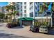 Lido Harbour Towers parking garage with cars parked in front at 1770 Benjamin Franklin Dr # 407, Sarasota, FL 34236