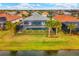 Aerial view of home with pool and lake view at 17722 Littleton Pl, Lakewood Ranch, FL 34202