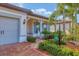 Inviting front porch with rocking chairs and nicely landscaped yard at 17722 Littleton Pl, Lakewood Ranch, FL 34202