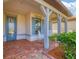 Front porch with rocking chairs and brick flooring at 17722 Littleton Pl, Lakewood Ranch, FL 34202