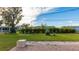 Landscaped backyard with a brick patio area at 1778 Palm Dr, Venice, FL 34293