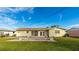 Backyard view showing a patio and a large lawn at 1778 Palm Dr, Venice, FL 34293