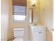 Small bathroom with vanity, toilet, and window at 1778 Palm Dr, Venice, FL 34293