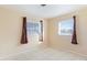 Well-lit bedroom with tile floors and two windows at 1778 Palm Dr, Venice, FL 34293