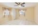 Bright bedroom with tile floors, ceiling fan, and ample closet space at 1778 Palm Dr, Venice, FL 34293