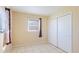 Bedroom with tile floors, window, and mirrored closet doors at 1778 Palm Dr, Venice, FL 34293