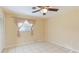 Spacious bedroom with tile floors and ceiling fan at 1778 Palm Dr, Venice, FL 34293