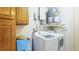 Laundry room with washer, dryer, and ample cabinet space at 1778 Palm Dr, Venice, FL 34293