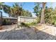 Landscaped backyard with shed and brick pavers at 180 Aurora Rd, Venice, FL 34293