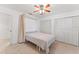 Bedroom with a murphy bed, ceiling fan, and ample closet space at 180 Aurora Rd, Venice, FL 34293