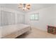 Bedroom with a murphy bed, ceiling fan, and decorative side table at 180 Aurora Rd, Venice, FL 34293