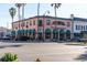 Two-story building with teal awnings and palm trees at 180 Aurora Rd, Venice, FL 34293