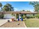 Single story home with a green door and well-manicured landscaping at 180 Aurora Rd, Venice, FL 34293