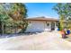 House exterior showcasing a white facade, attached garage, and landscaping at 180 Aurora Rd, Venice, FL 34293