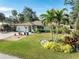 Well-maintained lawn with tropical landscaping and driveway at 180 Aurora Rd, Venice, FL 34293