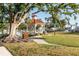 Relaxing gazebo with benches, shaded by a large tree, in a well-maintained park at 180 Aurora Rd, Venice, FL 34293