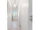 Hallway with neutral walls, tile floors, and built-in closet at 180 Aurora Rd, Venice, FL 34293