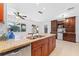 Kitchen with granite countertops, dark wood cabinets, and stainless steel appliances at 180 Aurora Rd, Venice, FL 34293