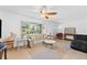 Living room featuring a light-colored couch and a ceiling fan at 180 Aurora Rd, Venice, FL 34293