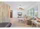 Living room with a light taupe couch, a chaise lounge, and a rustic wall at 180 Aurora Rd, Venice, FL 34293