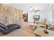 Living room with a light taupe couch, a chaise lounge, and a rustic wall at 180 Aurora Rd, Venice, FL 34293