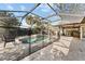 Inviting screened pool area with patio and outdoor kitchen at 180 Aurora Rd, Venice, FL 34293